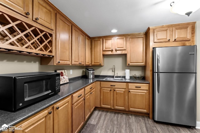 kitchen featuring sink, stainless steel refrigerator, and dark wood-type flooring