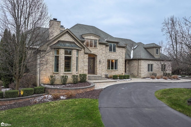 french provincial home with a front yard