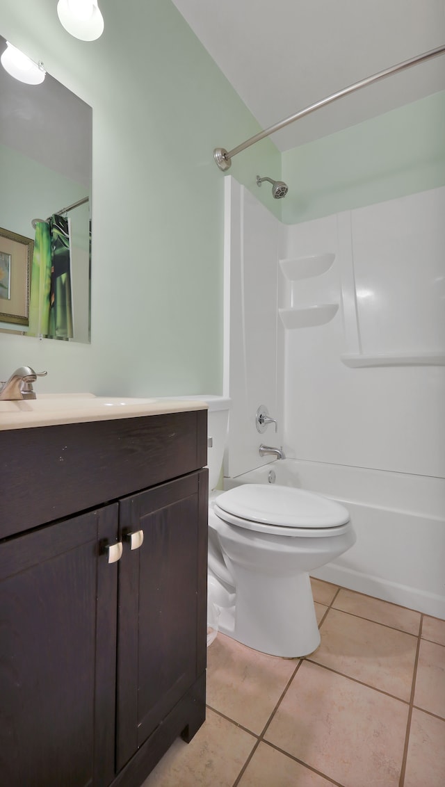 full bathroom featuring tile patterned floors, shower / tub combo with curtain, vanity, and toilet