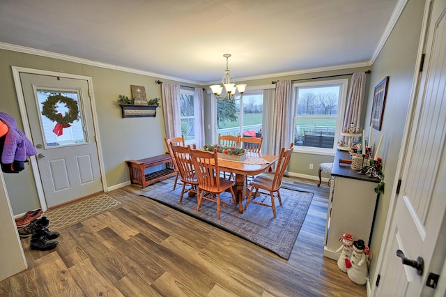 dining room with crown molding, a chandelier, and hardwood / wood-style floors