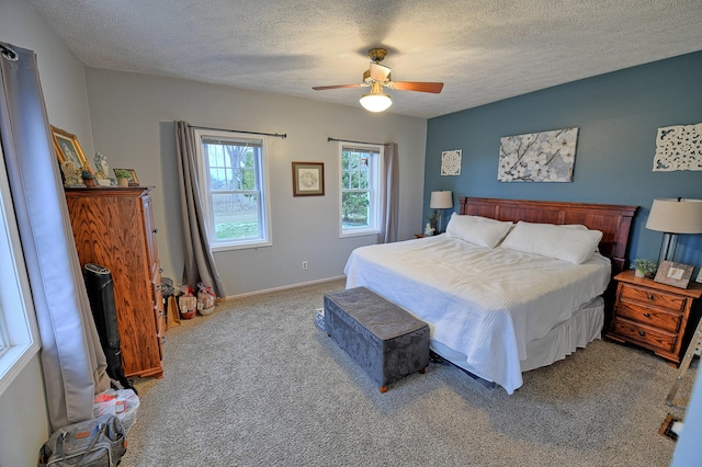 bedroom with carpet flooring, a textured ceiling, and ceiling fan