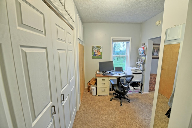 carpeted home office with a textured ceiling