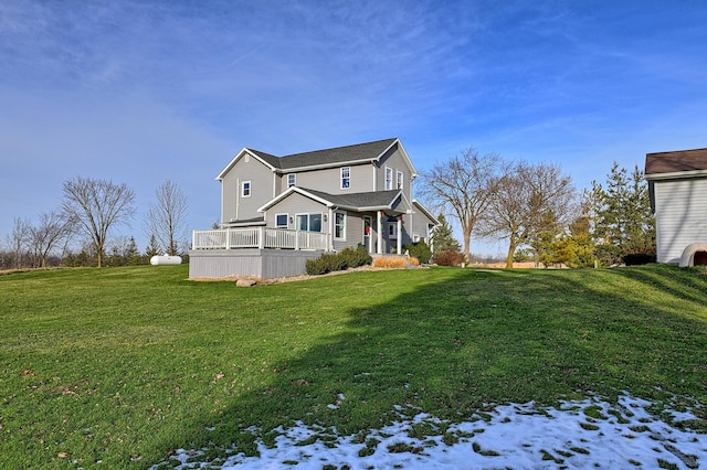 exterior space with a deck and a lawn