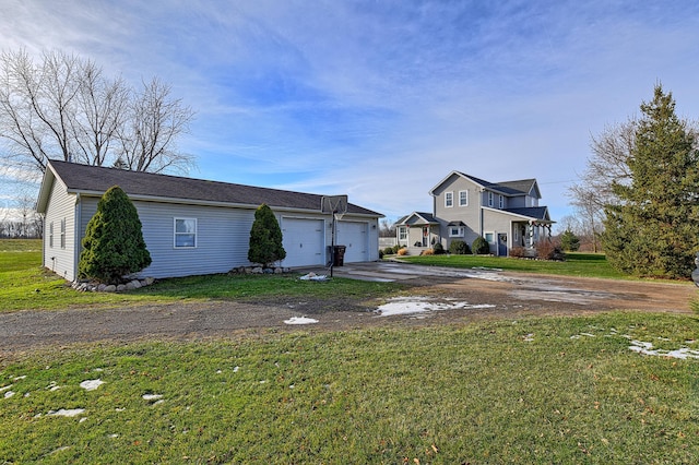 view of front of house with a garage and a front lawn