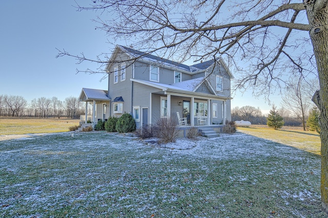 view of front of property with a front yard and covered porch