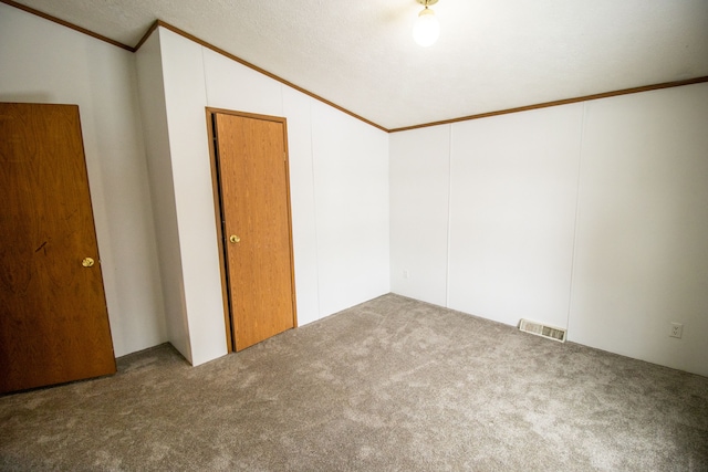 carpeted empty room featuring lofted ceiling