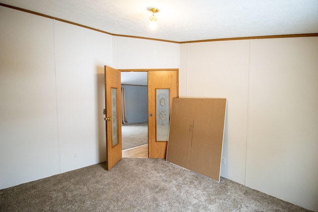 carpeted spare room with ornamental molding