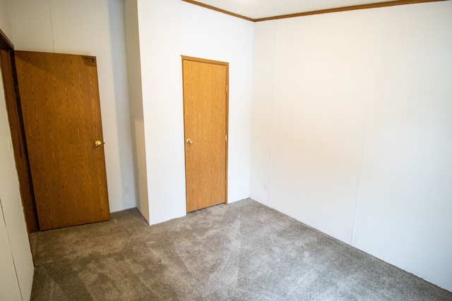 carpeted empty room with crown molding