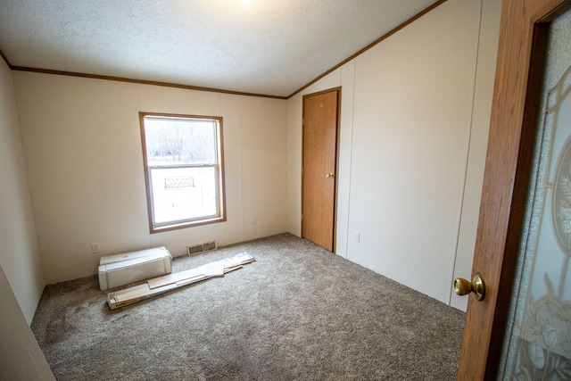 unfurnished bedroom featuring ornamental molding, carpet, and lofted ceiling