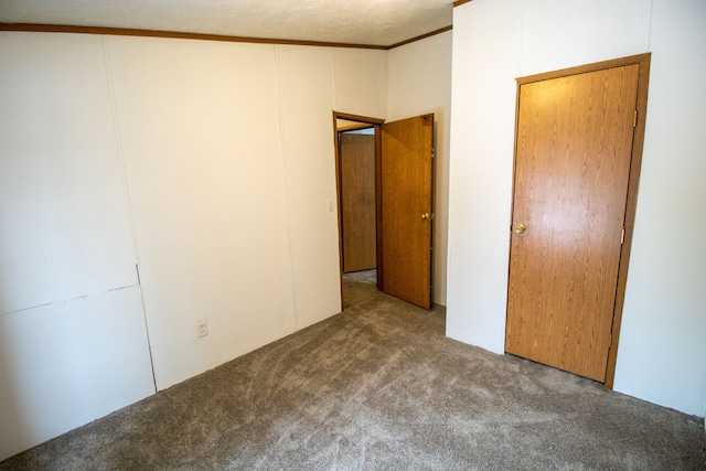 unfurnished bedroom with crown molding and carpet