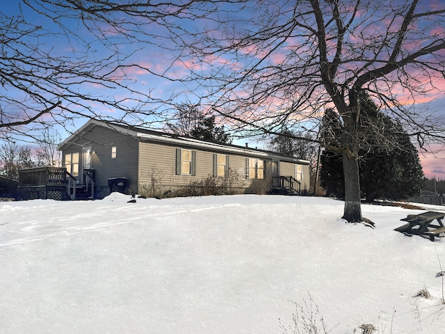 view of snow covered exterior featuring a wooden deck