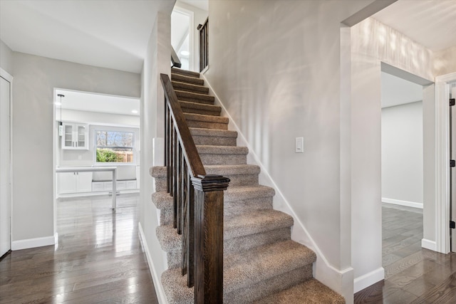 stairway featuring wood-type flooring