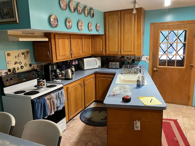 kitchen featuring sink, light tile patterned floors, exhaust hood, and white appliances