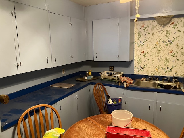 kitchen featuring sink and white cabinets