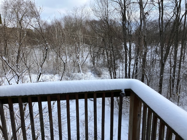 view of snow covered back of property