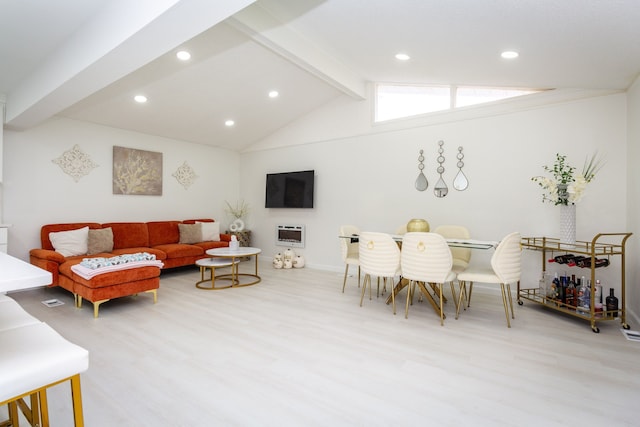 living room featuring lofted ceiling with beams and light hardwood / wood-style floors