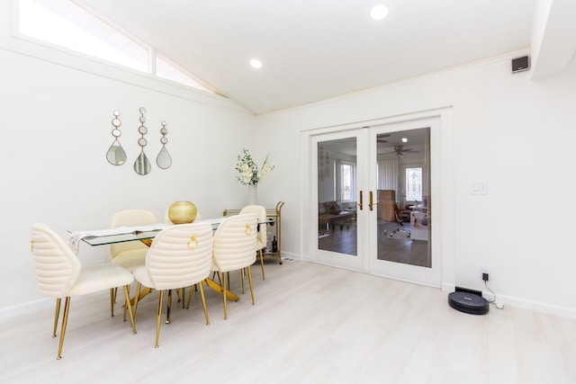 dining space featuring french doors, vaulted ceiling, and hardwood / wood-style flooring