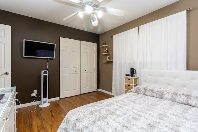 bedroom featuring ceiling fan, a closet, and dark wood-type flooring