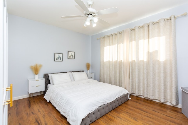 bedroom featuring ceiling fan and dark wood-type flooring