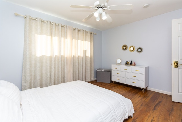 bedroom featuring ceiling fan and dark wood-type flooring