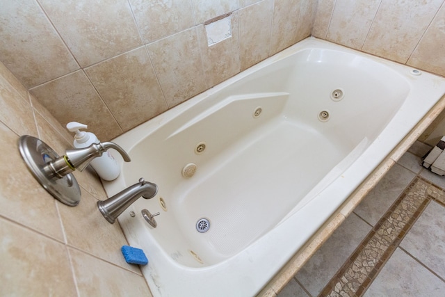 bathroom featuring tile patterned flooring and a tub