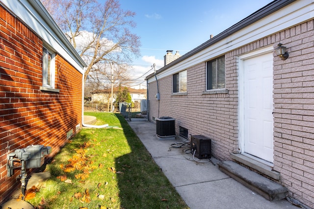 view of side of home with a yard