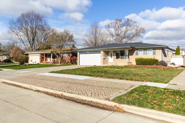 ranch-style home with a garage and a front yard