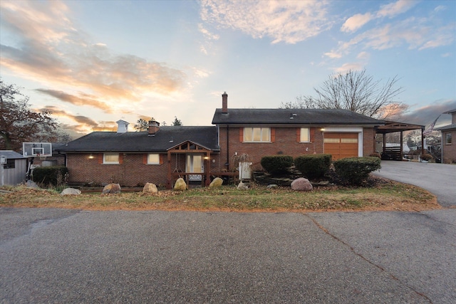 view of front of property with a garage and a carport