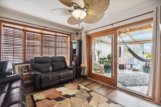 living room with hardwood / wood-style flooring, ceiling fan, and a healthy amount of sunlight