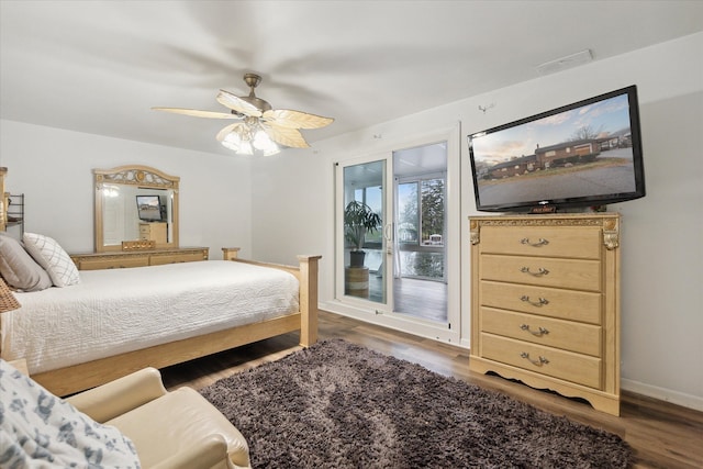 bedroom featuring access to outside, ceiling fan, and dark hardwood / wood-style floors