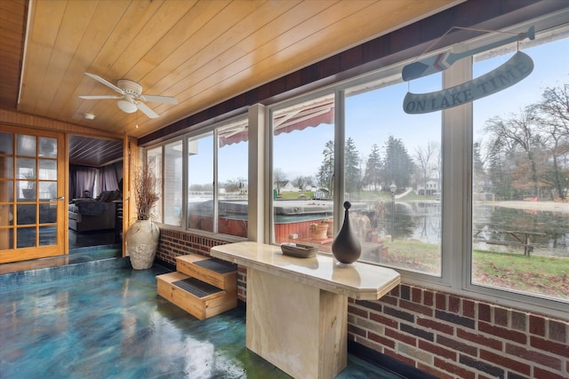 sunroom / solarium featuring a water view, ceiling fan, and wooden ceiling