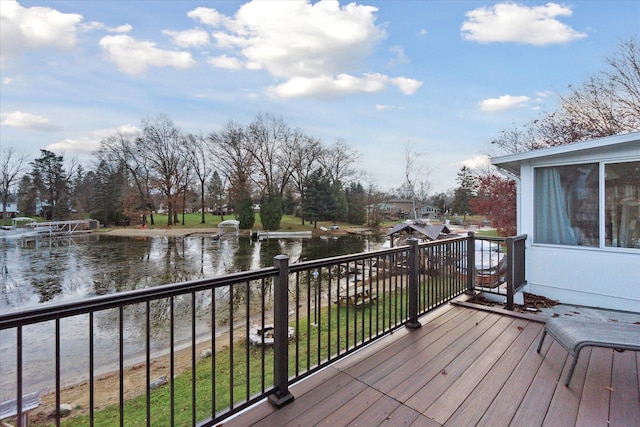 wooden terrace featuring a water view