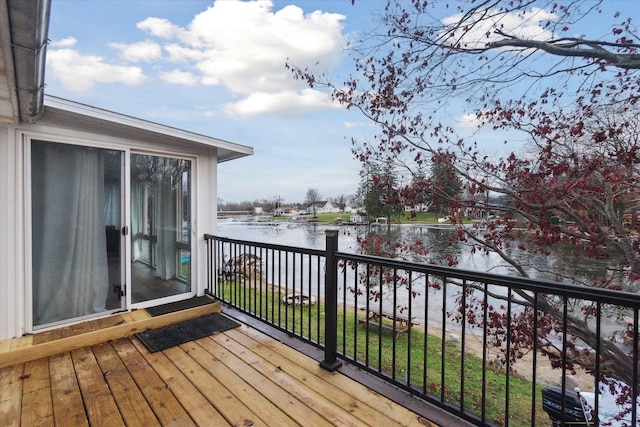 wooden terrace featuring a water view