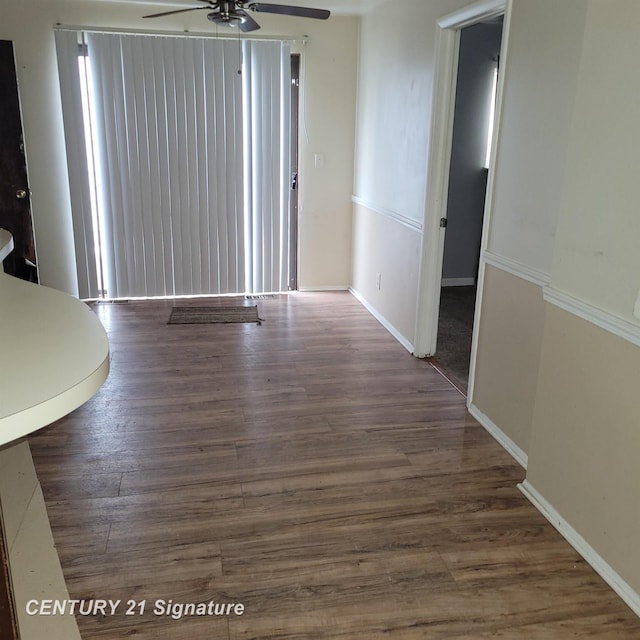 interior space featuring ceiling fan and dark hardwood / wood-style flooring