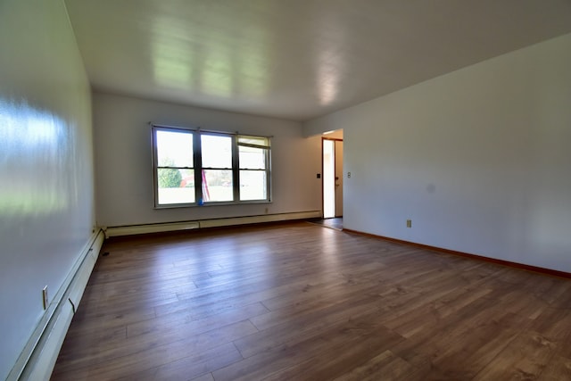 unfurnished room featuring dark hardwood / wood-style flooring and a baseboard radiator