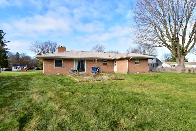 back of property featuring a lawn