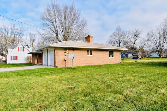 view of home's exterior with a garage and a lawn