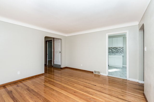 unfurnished room with light wood-type flooring