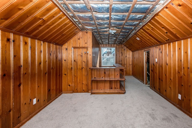 bonus room with lofted ceiling, carpet floors, and wooden walls