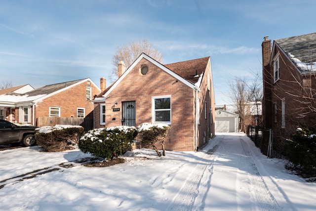 view of front of house featuring a garage and an outdoor structure