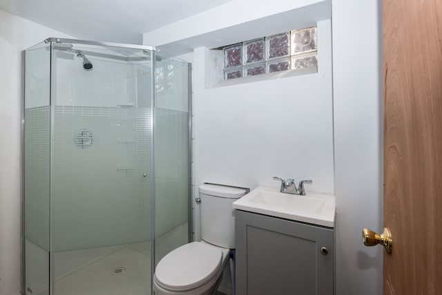 bathroom with vanity, walk in shower, and toilet