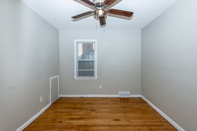 spare room featuring hardwood / wood-style floors and ceiling fan