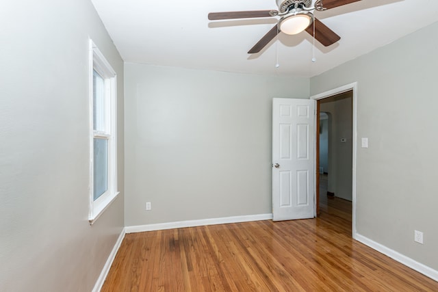 unfurnished room with ceiling fan, plenty of natural light, and light hardwood / wood-style floors