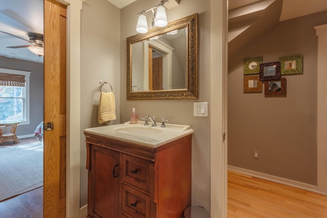 bathroom with vanity, hardwood / wood-style floors, and ceiling fan