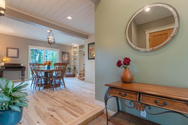 dining space with wood ceiling, built in features, and light hardwood / wood-style flooring