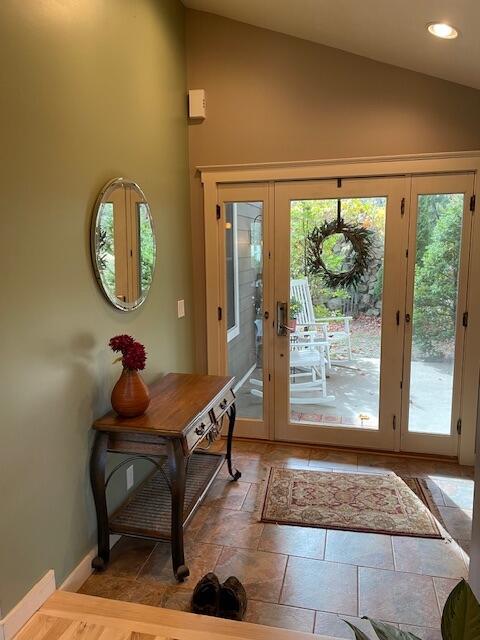 doorway with lofted ceiling and french doors