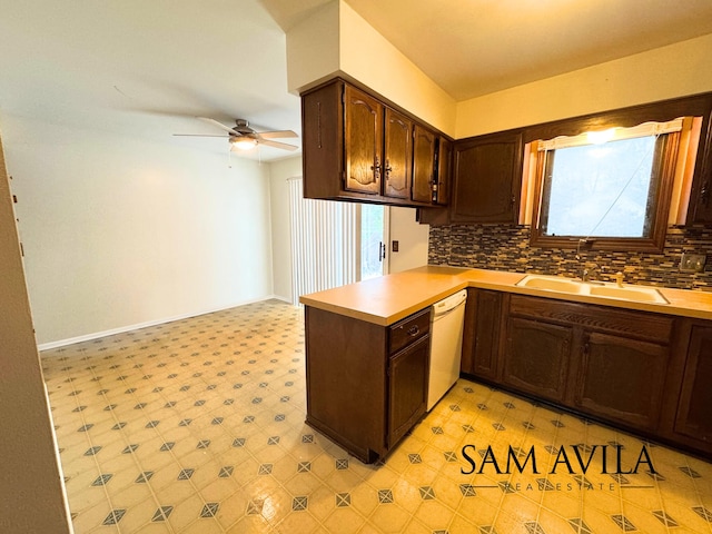 kitchen featuring kitchen peninsula, decorative backsplash, white dishwasher, ceiling fan, and sink