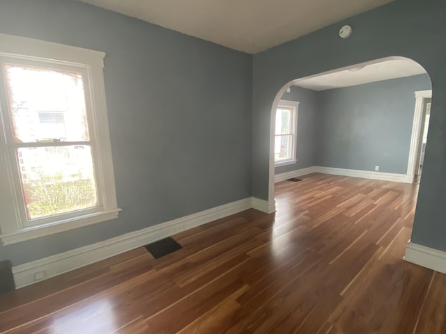 empty room with dark hardwood / wood-style flooring