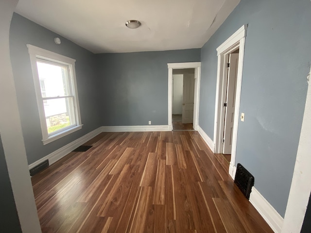 empty room with dark hardwood / wood-style floors