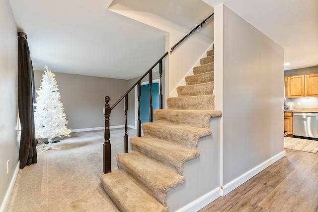 stairway with hardwood / wood-style floors